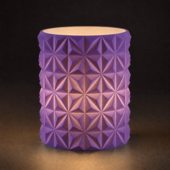 Close-up of the PrismGlow geometric LED tealight sleeve in Purple
