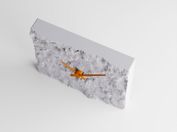 Front-angle close-up of the Stonewake table clock and chiseled stone-look face
