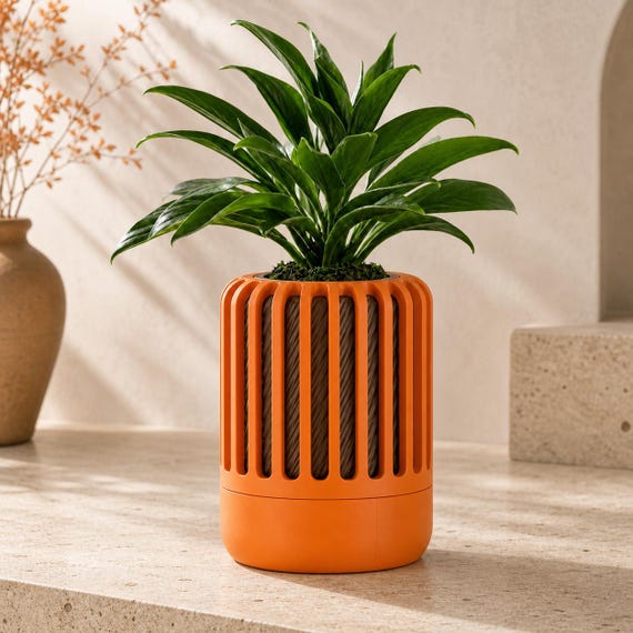 Close-up of the Reedshift sculptural planter in Pumpkin Orange and Cocoa Brown Harvest Clay colors