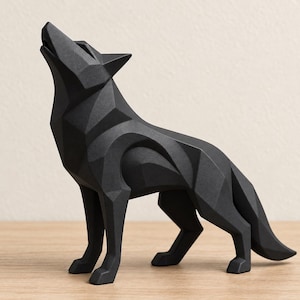 May include: A matte black geometric sculpture of a wolf in a howling pose. The figure is composed of sharp, angular facets and flat planes that define the animal's form, including its pointed ears, snout, and tail, creating a structured silhouette.