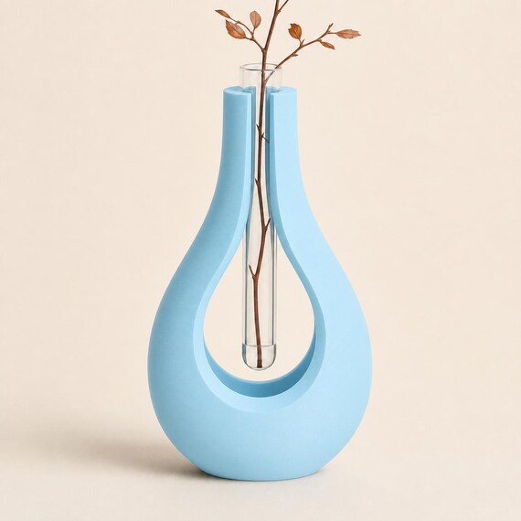 Close-up of the AerialArc sculptural stem holder in Ice Blue with a clear 15 mm tube