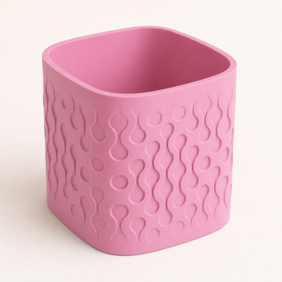Close-up elevated view of the Tidecell indoor planter in Sakura Pink showing the open top