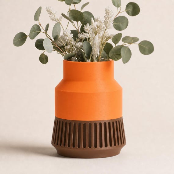 Close-up of the Tall StrataRise sculptural vase in Pumpkin Orange and Cocoa Brown