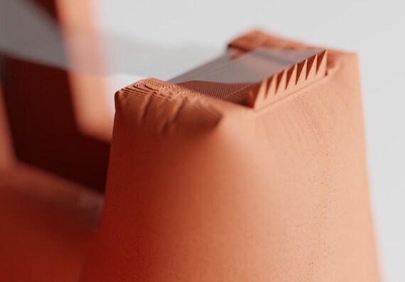 Close-up of the DrapeCut tape dispenser with its integrated serrated cutting edge