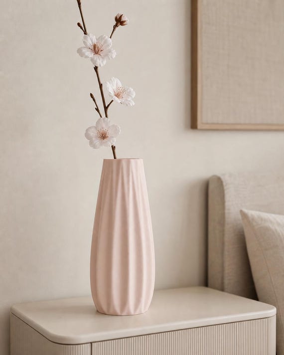 Close-up of a Sakura Pink Loomrise vase with delicate dried stems