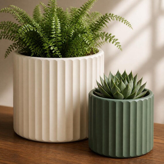 Close-up comparison of two proportional Quietline fluted planter sizes