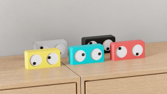 Wander Eyes Desk Clock colorful examples on oak from the alternate source angle, showing the paired eyes and rectangular bodies.