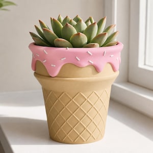 May include: A succulent plant potted in a ceramic planter shaped like an ice cream cone. The planter features a tan waffle-textured base and a pink glazed rim with white sprinkles, mimicking melting frosting on top of the cone.