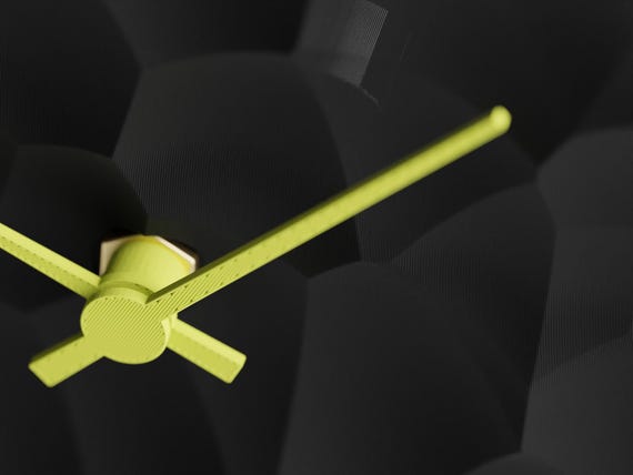 Detail view of the Facetfield clock movement and sculpted cellular face