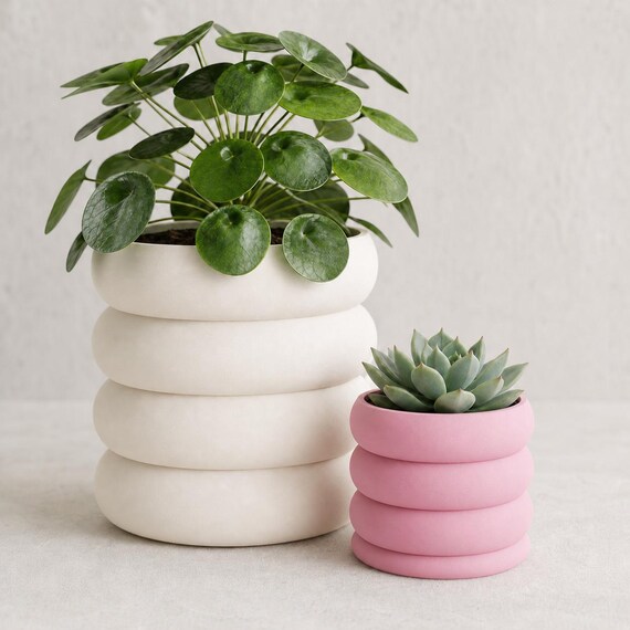 Close-up size comparison of large Bone White and small Sakura Pink Cascadewell planters