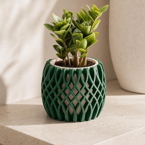 Close-up of the LatticeBloom plant pot with Mistletoe Green exterior and Beige interior
