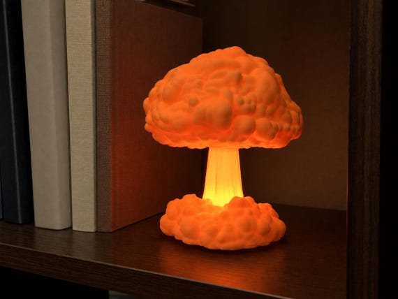 Normal Mandarin Orange Atomic Bloom lamp glowing with its flameless tea light