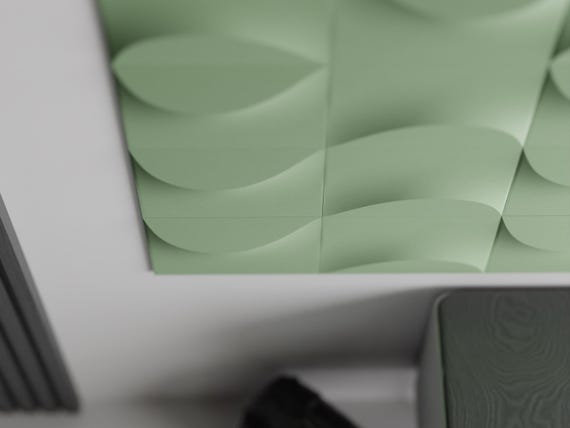 Angled close-up of green TideFold wall tiles showing the raised flowing crest