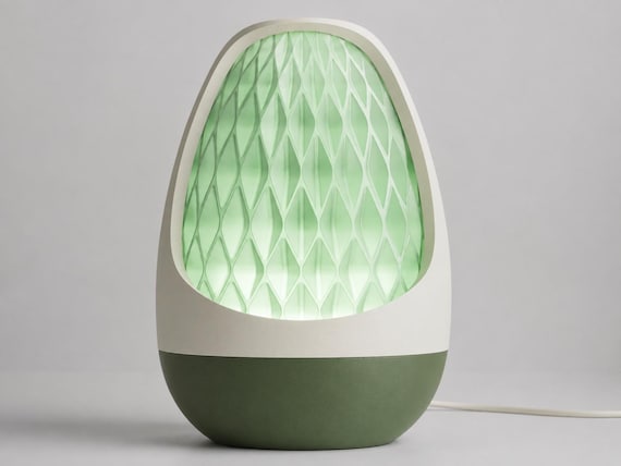 Lumenvale USB lamp in Jade Grove, assembled with a Bone White frame, Dark Green base and glowing Light Jade patterned shade on pale gray.