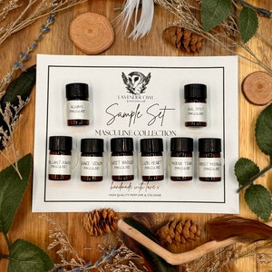 May include: A set of 8 small glass bottles with black caps and white labels. The labels have the names of different scents, including "Always Masculine", "Owl Post Masculine", "Brilliant Raven Masculine", "Snake Venom Masculine", "Sweet Badger Masculine", "Lion Heart Masculine", "Phoenix Tears Masculine", and "Forest Moonla Masculine". The bottles are arranged in two rows of four on a white background. The text "Lavender Owl Emporium Sample Set Masculine Collection handmade with love x High Quality Perfume & Cologne" is printed below the bottles.