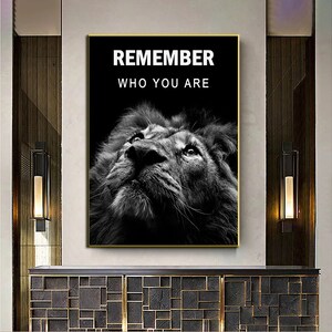 May include: Black and white motivational poster featuring a lion's face looking up with the text "REMEMBER WHO YOU ARE" in white.