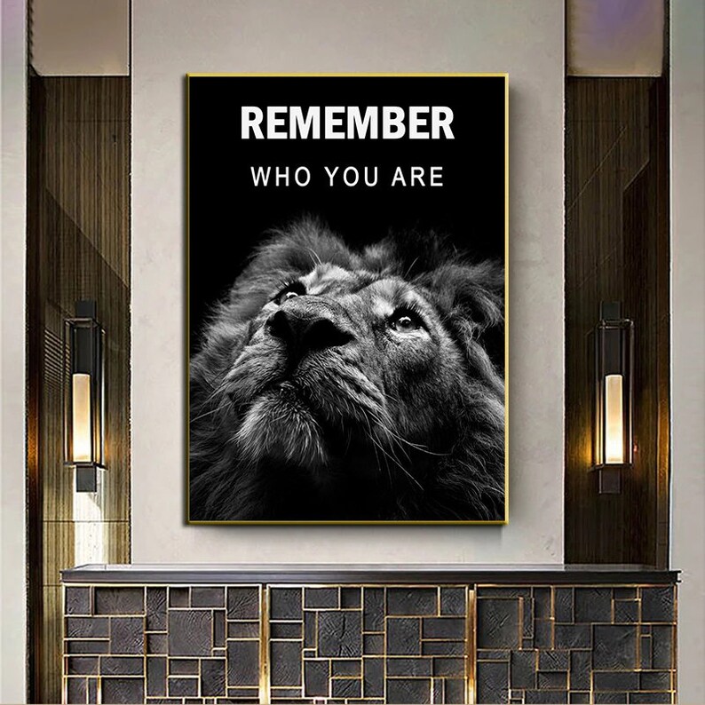 May include: Black and white motivational poster featuring a lion's face looking up with the text "REMEMBER WHO YOU ARE" in white.