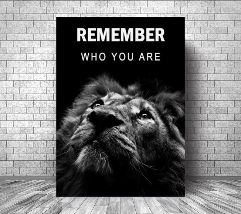 May include: Black and white motivational poster featuring a lion's face with the text "REMEMBER WHO YOU ARE" in white.