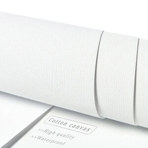 May include: Close-up of a white cotton canvas roll. The text "Cotton canvas", "High quality", and "Waterproof" is printed on a white label.
