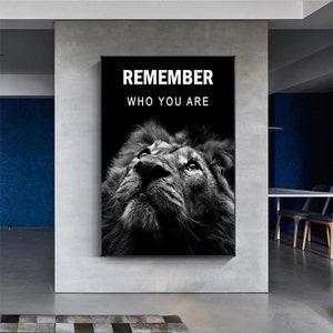 May include: Black and white motivational poster featuring a lion's face with the text "Remember who you are".