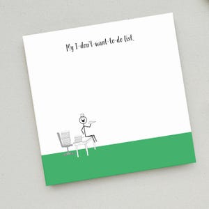 May include: A white notepad with the text "My I-don't-want-to-do list."  A stick figure illustration of a person sitting at a desk with a stack of papers and a paper airplane in their hand.