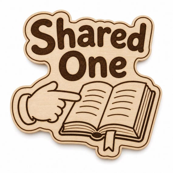 Sharing Light engraved birch reward badge with Shared One artwork shown close up on white.