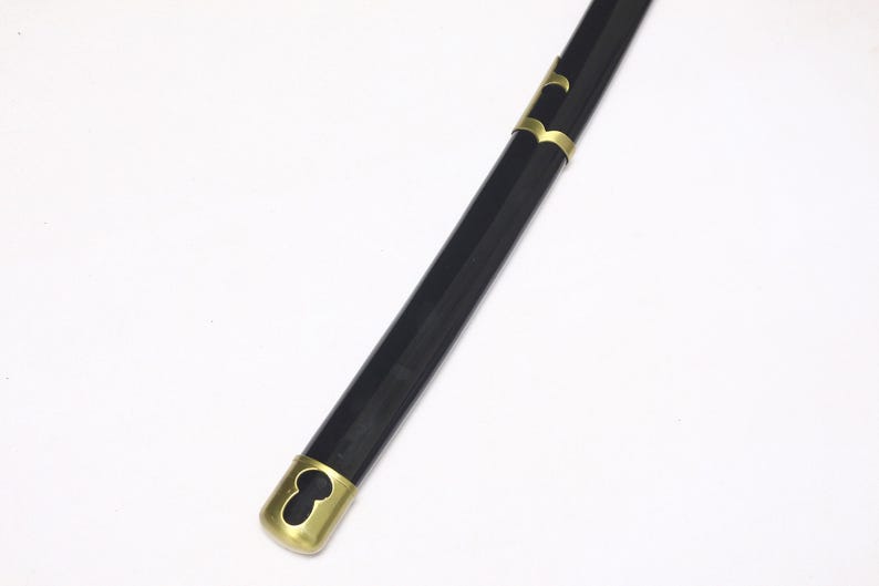A close-up of the black katana scabbard, showing a gold cap at the end and gold accents along its length.