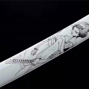 Close-up of a white katana scabbard with a black line art drawing of a geisha holding a small sword.