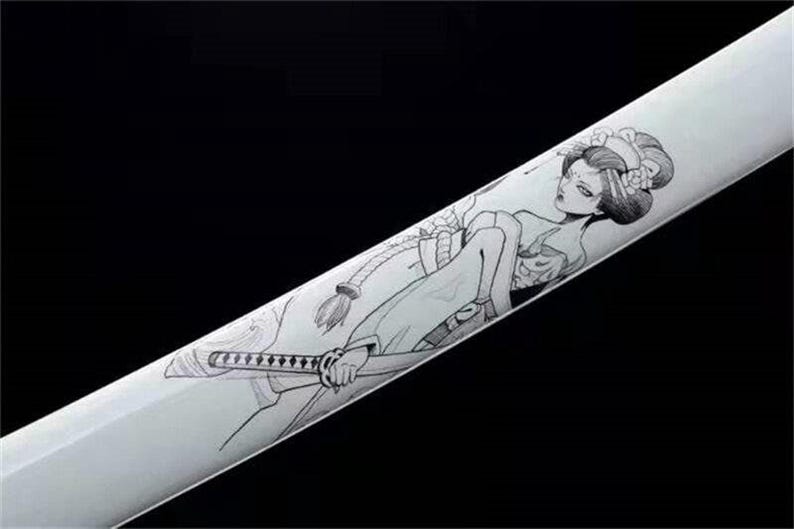 Close-up of a white katana scabbard with a black line art drawing of a geisha holding a small sword.