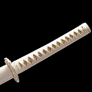 Close-up of a white katana hilt wrapped in white cord with a diamond pattern, showing a silver-colored guard.