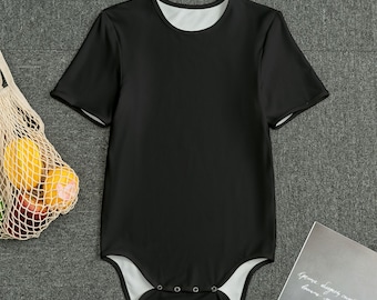 May include: Black short-sleeved bodysuit with a white trim around the neckline and poppers at the bottom.