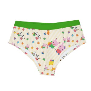 May include: Brief-style underwear featuring a green waistband and a repeating pattern of pandas, pigs, and toy trains on a cream background with vertical stripes. The cartoon characters are in various colours.