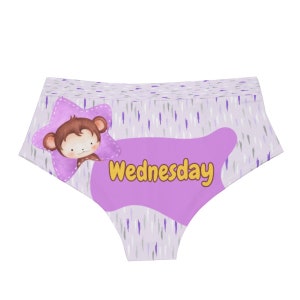 May include: Light purple underwear with a repeating pattern of vertical lines in gray and purple. A purple star with a cartoon monkey is on the left. The word "Wednesday" is in yellow on a purple shape.