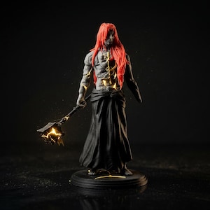 May include: A detailed figurine of a character with red hair and a black robe. The figure holds a glowing weapon and has glowing accents on its body. The base is black, and the background is dark.