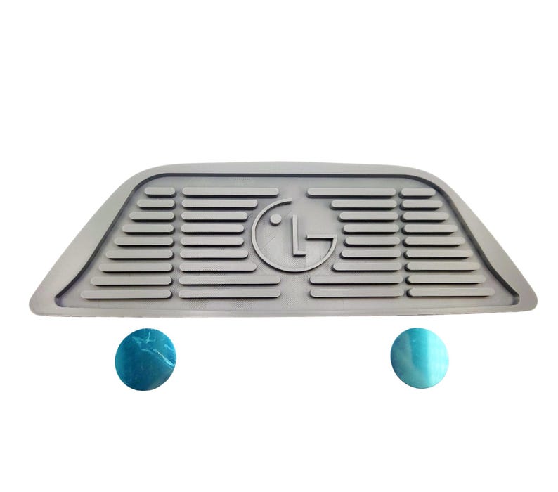 Puede incluir: Tap&oacute;n de puerta de goma gris con un logotipo LG en relieve y una superficie texturizada. El tap&oacute;n de puerta tiene forma de cu&ntilde;a y tiene dos pies redondos de goma azul.