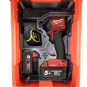 May include: A red and black Milwaukee FUEL impact driver with a 5.0 Ah REDLITHIUM-ION M18 battery, a black and yellow Stanley 8m tape measure, and a red and black ONE-KEY battery in a red plastic tool box.