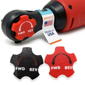May include: A red and black power tool with a red directional dial labeled "FWD REV." The tool has a "Made in USA" tag and the "socal3d" logo. Two additional directional dials, one black and one red, are also shown.