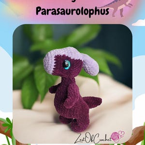 May include: A handmade crochet dinosaur toy in shades of purple and lavender, with large blue eyes. The text "Slinky the Parasaurolophus" is displayed above the toy, and the Zest Of Crochet logo is at the bottom.