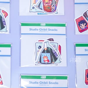 May include: Multiple packs of Studio Ghibli Snacks stickers. Each pack contains several stickers with colorful illustrations of anime food and characters. The stickers are packaged in clear plastic with a green and white header that reads "Studio Ghibli Snacks".