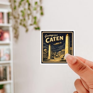 May include: A square sticker with a vintage travel poster design. The sticker features a night scene with two obelisks, buildings, and the text "Greetings from CATEN". The color palette includes navy, gold, and beige.