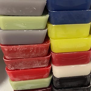 May include: A stack of rectangular wax blocks in various colors, including gray, green, yellow, red, white, and black.