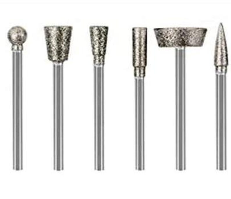 May include: Set of seven diamond-tipped rotary tool bits for grinding, carving, and polishing. The bits are made of high-quality materials and are designed for long-lasting use.