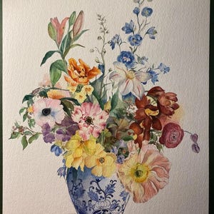 May include: Watercolor painting of a vibrant floral arrangement in a blue and white patterned vase. The bouquet features a variety of flowers in shades of pink, yellow, orange, purple, and blue. The artwork is set against a white background.