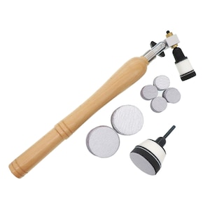 May include: A wooden sanding tool with a rotating head and a set of sanding pads. The tool has a long wooden handle and a metal attachment for changing sanding pads. The sanding pads are round and come in various sizes.