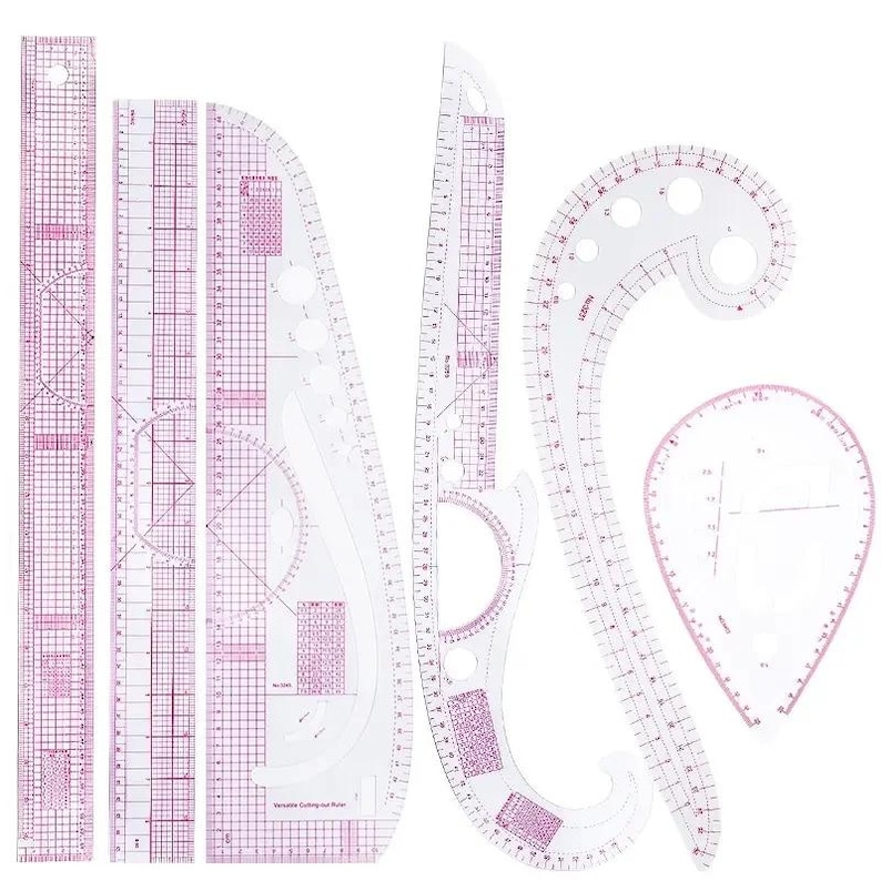 May include: A collection of clear plastic sewing rulers and curves with pink grid lines and markings. Includes straight rulers, French curves, and a hip curve, ideal for pattern making and garment construction.