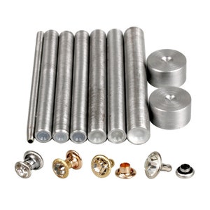 May include: A set of metal tools for setting rivets, including a punch, a hammer, and a set of dies. The set also includes a variety of decorative rivets with clear, gold, and silver accents.