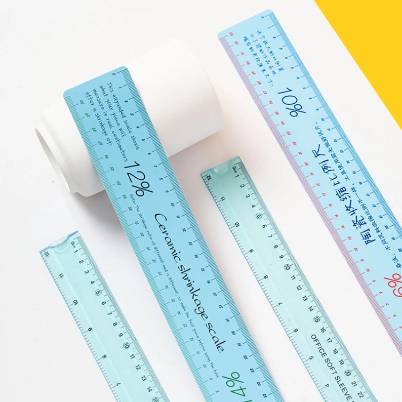May include: Four blue plastic rulers with different scales. The rulers are marked with percentages and centimeters. The text on the rulers reads "Ceramic shrinkage scale" and "12%", "10%", and "4%".