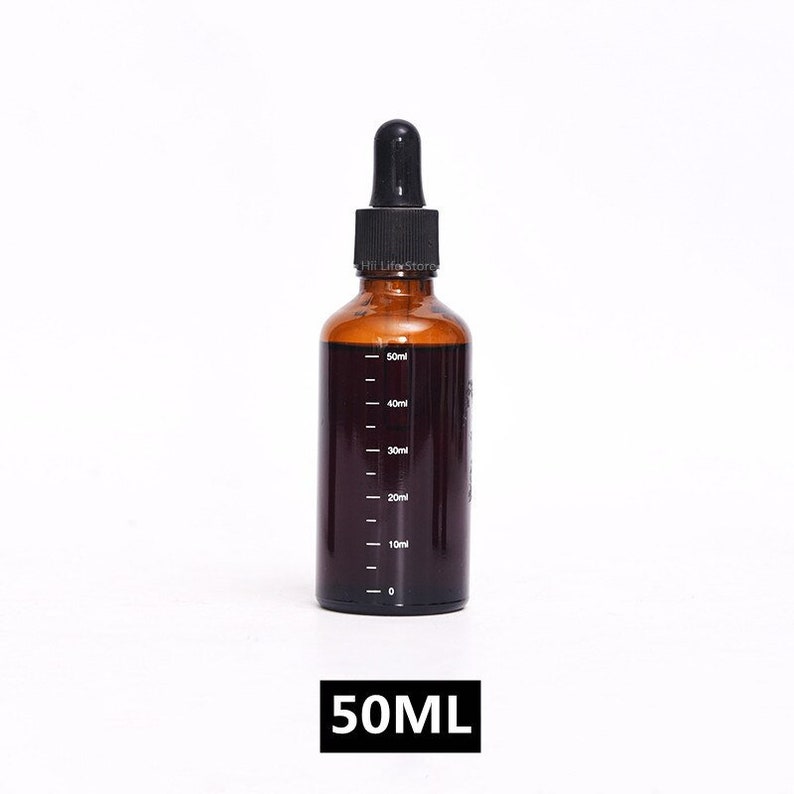 May include: A brown glass bottle with a black dropper top. The bottle has a clear liquid inside and markings on the side indicating milliliters. The bottle is labeled "50ML".