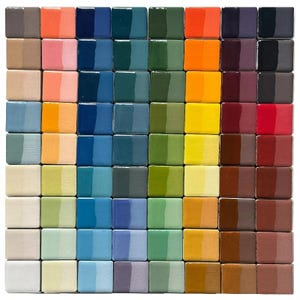 May include: A grid of 64 small, square ceramic tiles in a variety of colors. The tiles are arranged in an 8x8 grid, showcasing a spectrum of hues from cool blues and greens to warm oranges and reds. Each tile has a glossy finish.