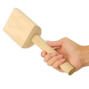 May include: A wooden mallet with a square head and a long handle. The mallet is made of light-colored wood and has a smooth finish.